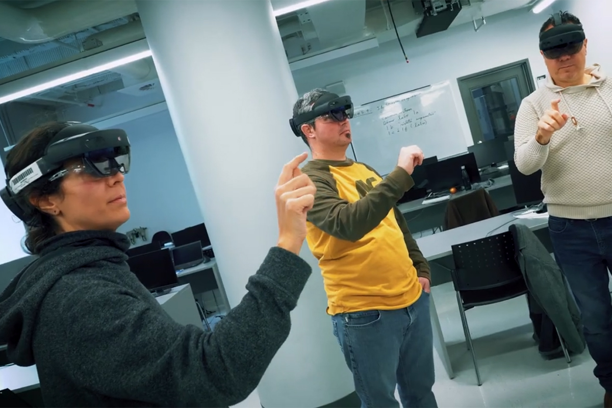 Trois personnes utilisent des casques de réalité virtuelle dans une classe