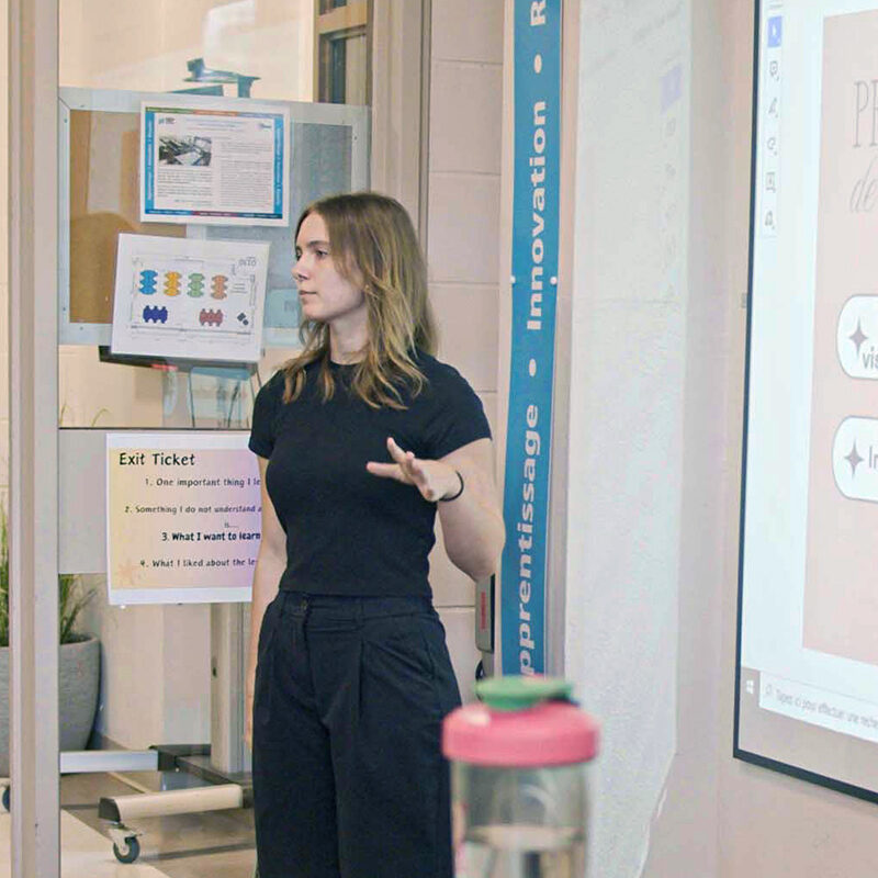 Une jeune femme s'adresse à une classe